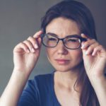 A woman with eyesight problems sees poorly through glasses.